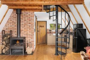 a kitchen with a brick wall and a stove at Kaszuby Lake View in Żuromino +37 photos