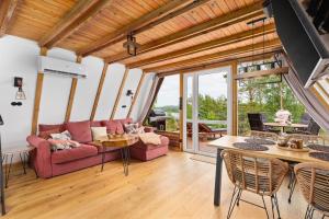 a living room with a couch and a table at Kaszuby Lake View in Żuromino