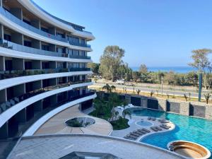a view of a building with a swimming pool at Via Mar Residence - Alanya Experience in Alanya