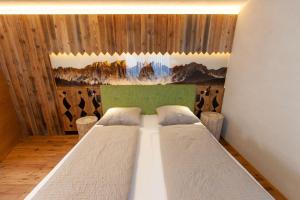 a bedroom with two beds in a room at Biohof Oberwerkstatt HAIDI in Obereggen