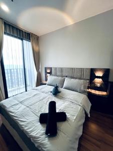 a large bed with a black cross on it at Lumi Homes at i-City - WiFi TV Box 1 Carpark in Shah Alam