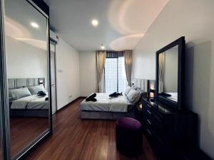 a bedroom with two beds and a large mirror at Lumi Homes at i-City - WiFi TV Box 1 Carpark in Shah Alam