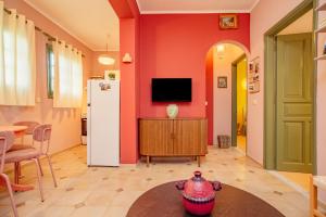 a living room with a refrigerator and a table at Yiayia's Guesthouse in Ýpsos