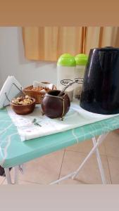 a table with a bowl of food and a purse on it at Chayerita - Suite en La Rioja in La Rioja