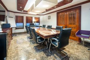 a conference room with a large wooden table and chairs at Mayfair House in London