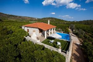 an aerial view of a house with a swimming pool at Aigli Villa Drepano in Drepana