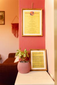 a table with a vase and a sign on a wall at Yiayia's Guesthouse in Ýpsos +30 photos