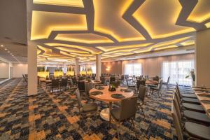 a rendering of a dining room with tables and chairs at Green Garden Hotel in Raszyn