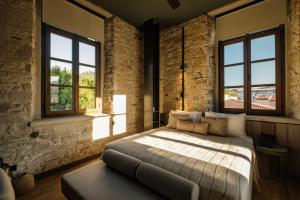 a bedroom with a bed and two windows at Lecole Hotel By Cityloft in Yenifoça +65 photos