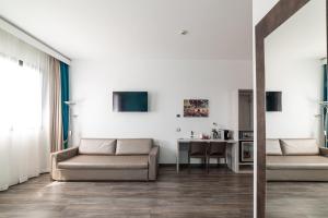 a living room with a couch and a table at Phi Hotel Milano in Baranzate