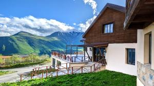 a house with a view of a mountain at Alpina Hotel in Gudauri
