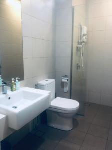 a bathroom with a sink and a toilet and a mirror at Luxe Homes at i-City - WiFi TV Box & 1 Carpark in Shah Alam