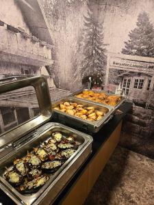 a buffet with many trays of food on a table at Garden Depandance Am Bach in Kurort Altenberg