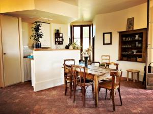 a dining room with a wooden table and chairs at La Tour Beurdelaine in Avallon