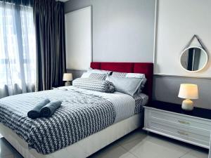 a bedroom with a bed with a mirror and a window at Maple Homes at i-City - WiFi TV Box and 1 Carpark in Shah Alam