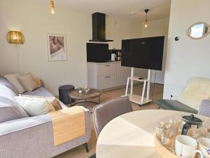 a living room with a couch and a table at Vakantiehuis Domburg DO60 in Domburg