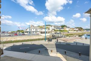a view of a city with a river and buildings at Le Bassin in Port-en-Bessin-Huppain
