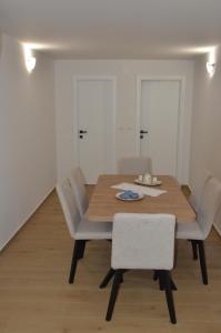 a dining room with a wooden table and chairs at Angelina in Jakišnica +10 photos