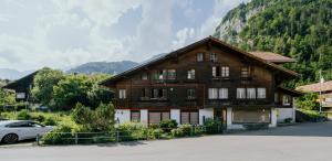 a house with a car parked in front of it at Mountain View near Brienz - free parking in Kienholz