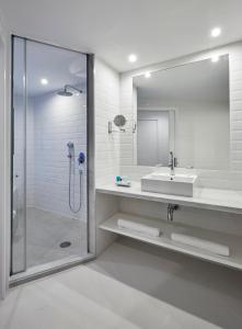 a bathroom with a sink and a shower with a mirror at Delamar 4*Sup-Adults only (18+) in Lloret de Mar