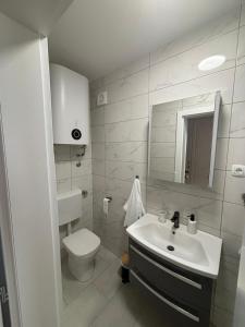 a white bathroom with a sink and a toilet at Angelina in Jakišnica