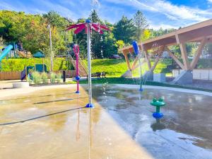 a water park with a fountain with an umbrella at LAÖ Loft Tremblant #106 - KING size Bed in Mont-Tremblant