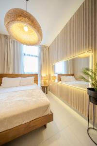 a bedroom with a bed and a large chandelier at Forest Honeymoon Suite With Pool View by BlueCloud holidays in Sharjah