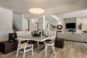 a dining room and living room with a table and chairs at Dazzling Almancil Villa Villa Magorian 4 Bedrooms Spacious Furnished Sun Terrace Private Outdoor Pool Bbq Facilities Shaded Outdoor in Almancil
