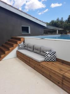a couch on a patio next to a swimming pool at Regia Hotel in Abbasanta