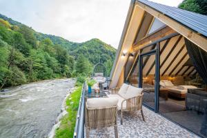 a room with chairs and a view of a river at Danzi camping tiny house in Kise