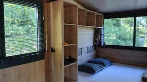 a small room with a bed and a window at Camping Onlycamp du lac de Roybon in Roybon