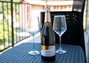 a bottle of wine and two wine glasses on a table at Chill & View BGY 20 min 