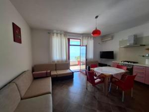 a living room with a couch and a table at Sunset Spille in Rrogozhinë +11 photos