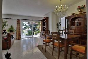 a dining room with a wooden table and chairs at Villa Quadradinhos 21Q 4 Bedroooms Private Pool Vale Do Lobo in Vale do Lobo