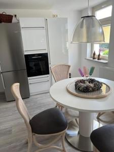 a kitchen with a table and chairs in a kitchen at Kerstins Lieblingsdomizil in Oelsnitz +10 photos