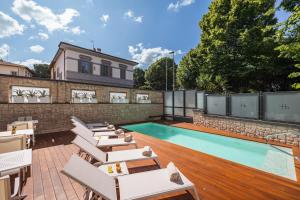 a patio with lounge chairs and a swimming pool at LHP River Club in Florence
