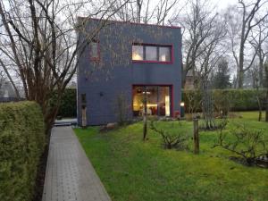 a house that is sitting in the grass at Tinyhaus in Woltersdorf