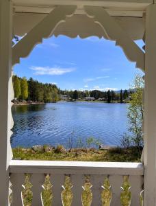 a view of a lake from a balcony at Glampingtelt i fjordkanten, Rønlund Hyttepark in Ron