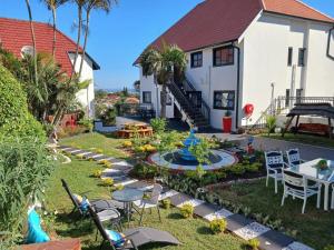 a house with a garden in front of it at Orca Estate Guesthouse Self-catering Accommodation in Durban