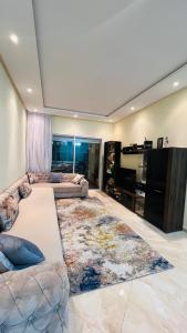a living room with a couch and a large rug at CASABAY KETTANI SIDI Rahal in Sidi Rahal +20 photos