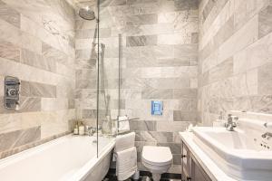a bathroom with a shower and a toilet and a sink at Spacious High End 3-Bedroom Apartment Sleeps 6 in Midland +14 photos