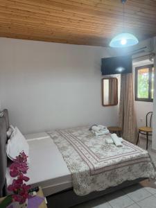 a bedroom with a large bed and a blue ceiling at AVRA Rooms in Therma