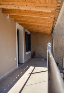 a porch of a building with a wooden ceiling at Anestis Apartments in Kontokali