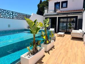 a villa with a swimming pool and a house at Medusa Luxury Marina in Vilamoura