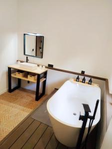 a bathroom with a bath tub and a sink at Casa Ariadna in Bocairent