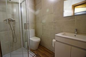 a bathroom with a shower and a toilet and a sink at Casa Vale da Fonte in Geres +13 photos