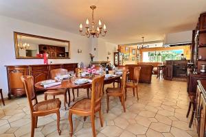 a kitchen and dining room with a table and chairs at Villa cafe marrec 4 in Port-Louis +14 photos