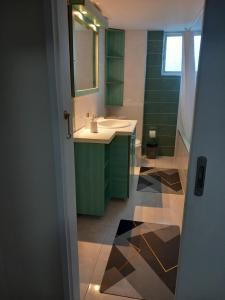 a bathroom with a sink and a mirror at Nikos apartment in Sparti +50 photos