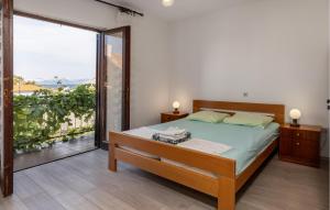a bedroom with a bed and a large window at 4 Bedroom Awesome Apartment In Sveti Juraj in Sveti Juraj