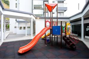 a playground in a building with a slide at Serene Japandi Family Retreat 2-6 pax& Sunrise View in Brinchang